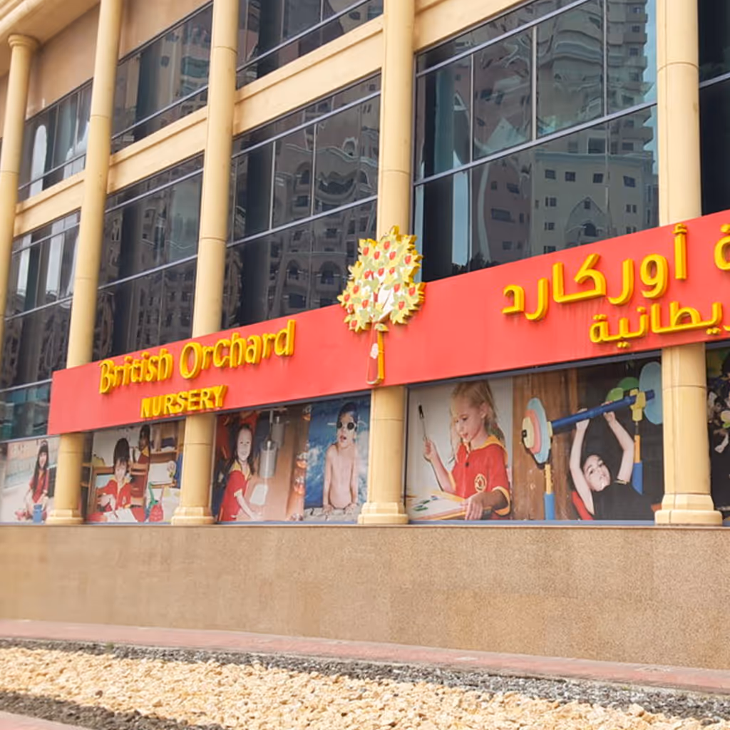 Facade of British Orchard Nursery with large windows and images of children engaged in various activities.